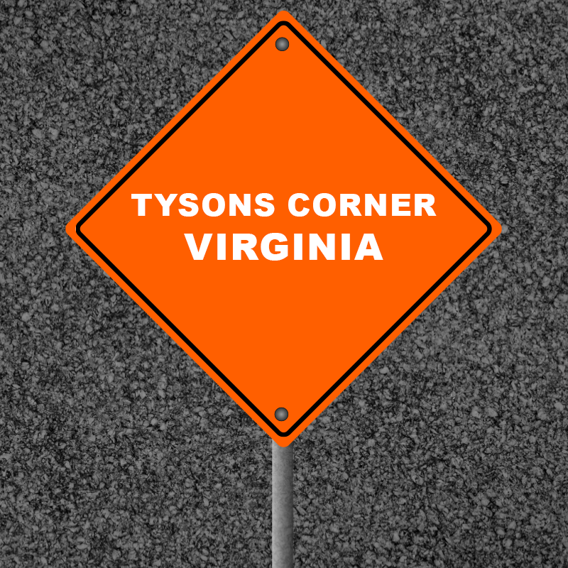 Tysons Corner Virginia road sign on asphalt background, highlighting the location's significance in Northern Virginia's commercial landscape.